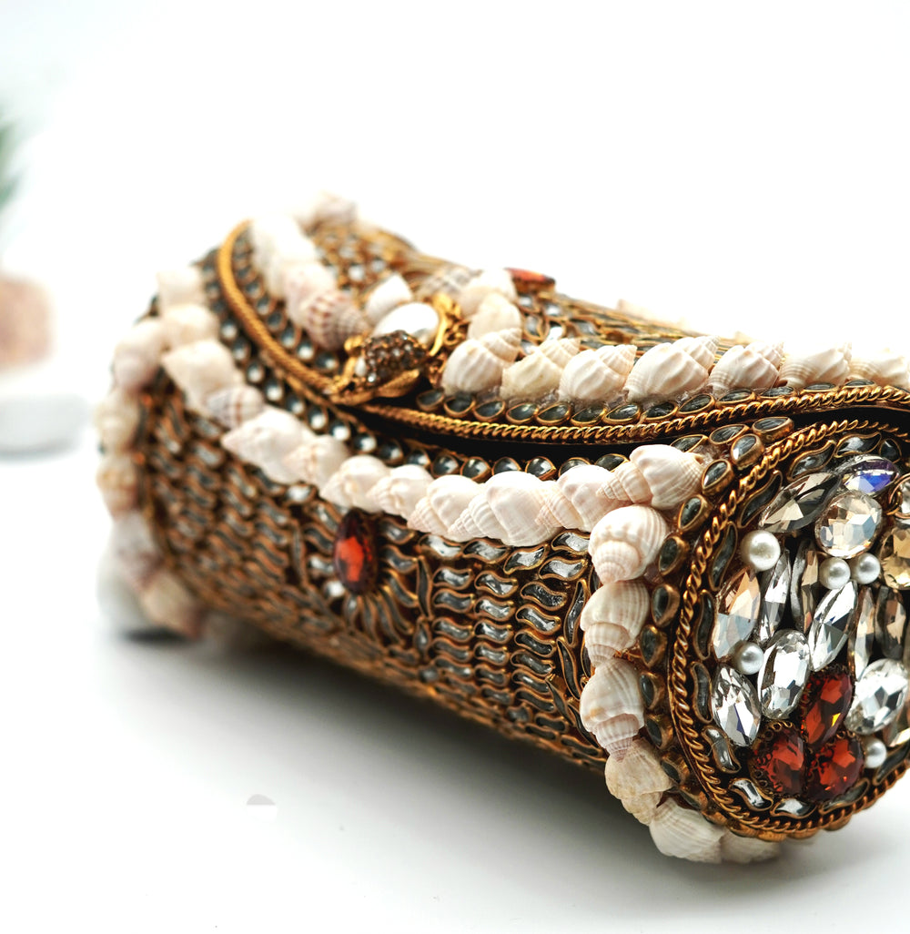 Decorative clutch with beads and gemstones on a white background