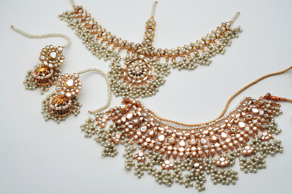 Jewelry set with necklace and earrings on a light background